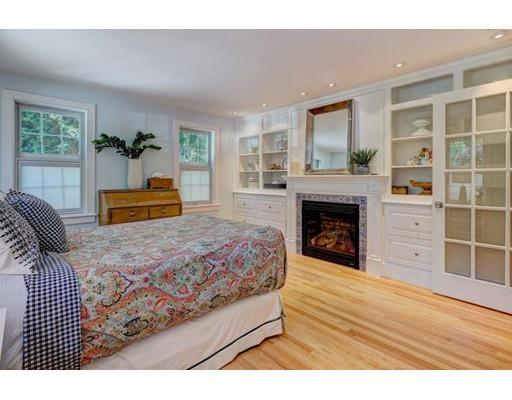646 South Orleans Road Orleans, MA 02653 - Photo 19 of 42 a bedroom with a large bed and a fireplace