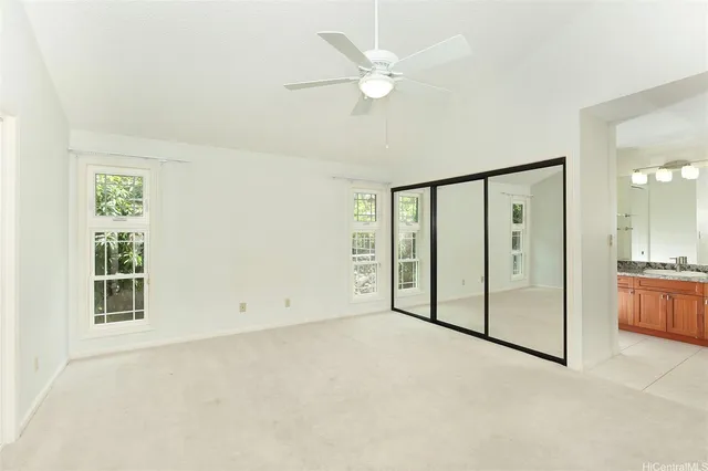 an empty room with windows and closet