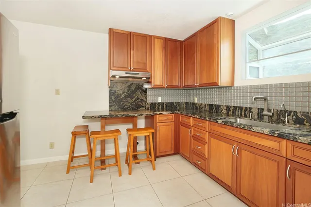 a kitchen with stainless steel appliances kitchen island granite countertop a sink and cabinets