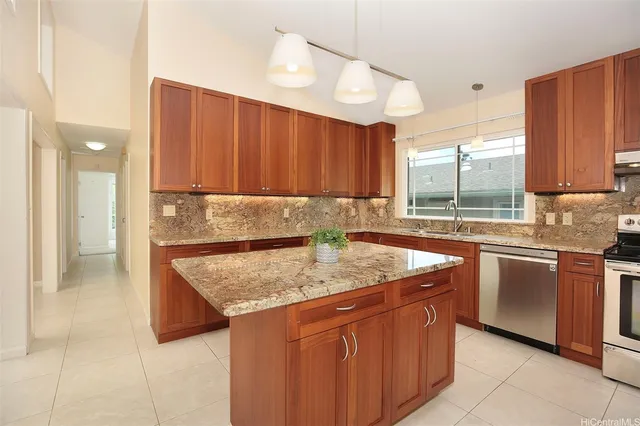 a kitchen with granite countertop sink stove and cabinets