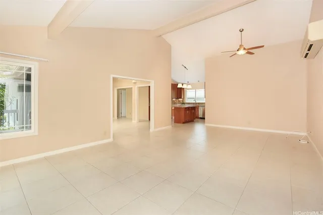 an empty room with windows and cabinet