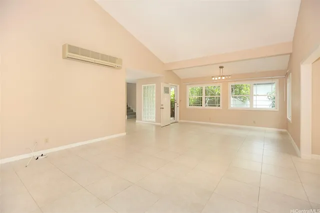 an empty room with windows and entrance