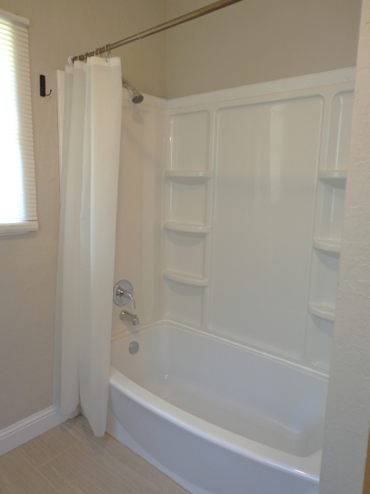 181 Washington Avenue Camden, TN 38320 - Photo 11 of 68 a bathroom with a shower and a bath tub