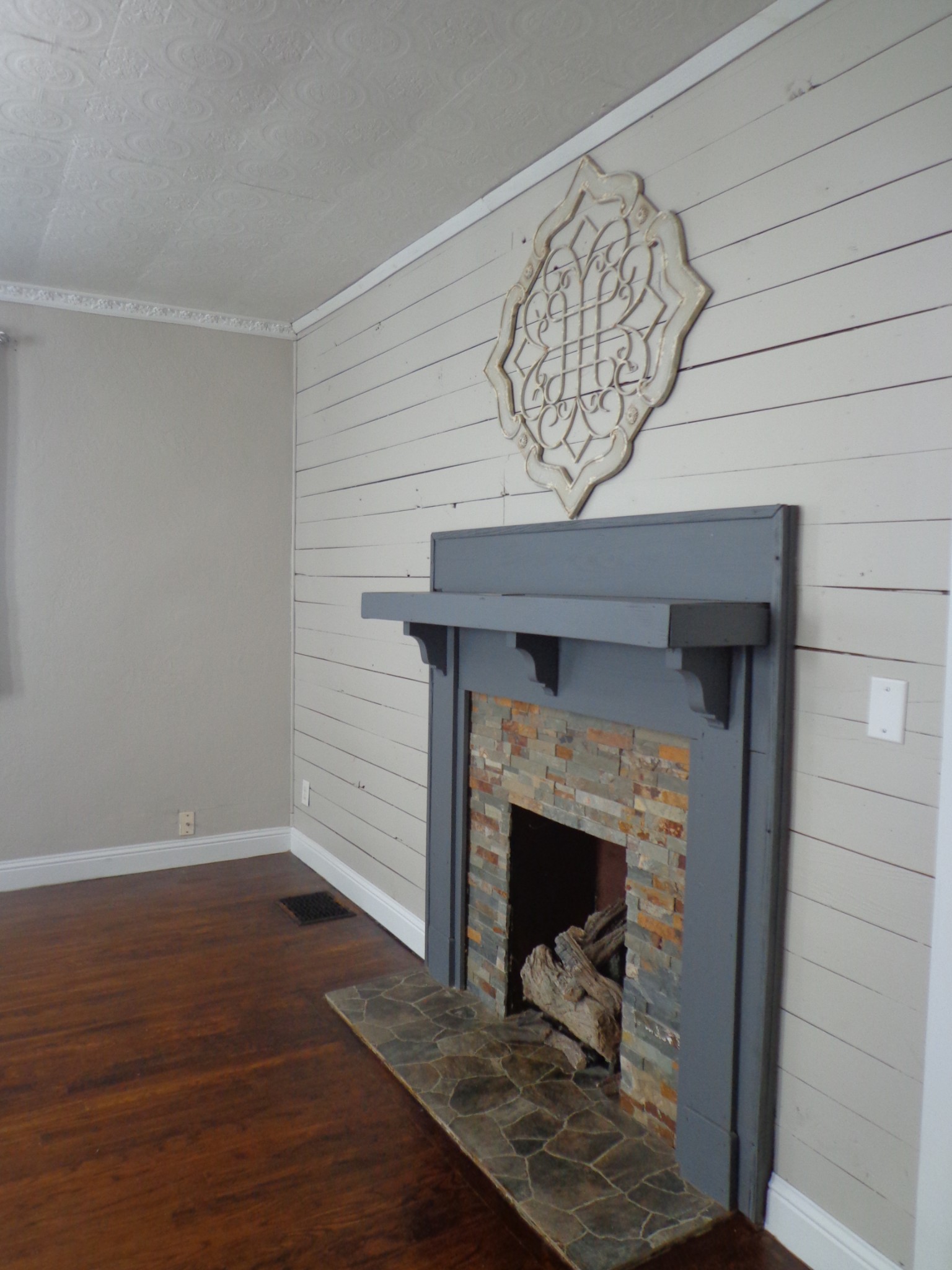 181 Washington Avenue Camden, TN 38320 - Photo 20 of 68 a view of a livingroom with wooden floor and a fireplace