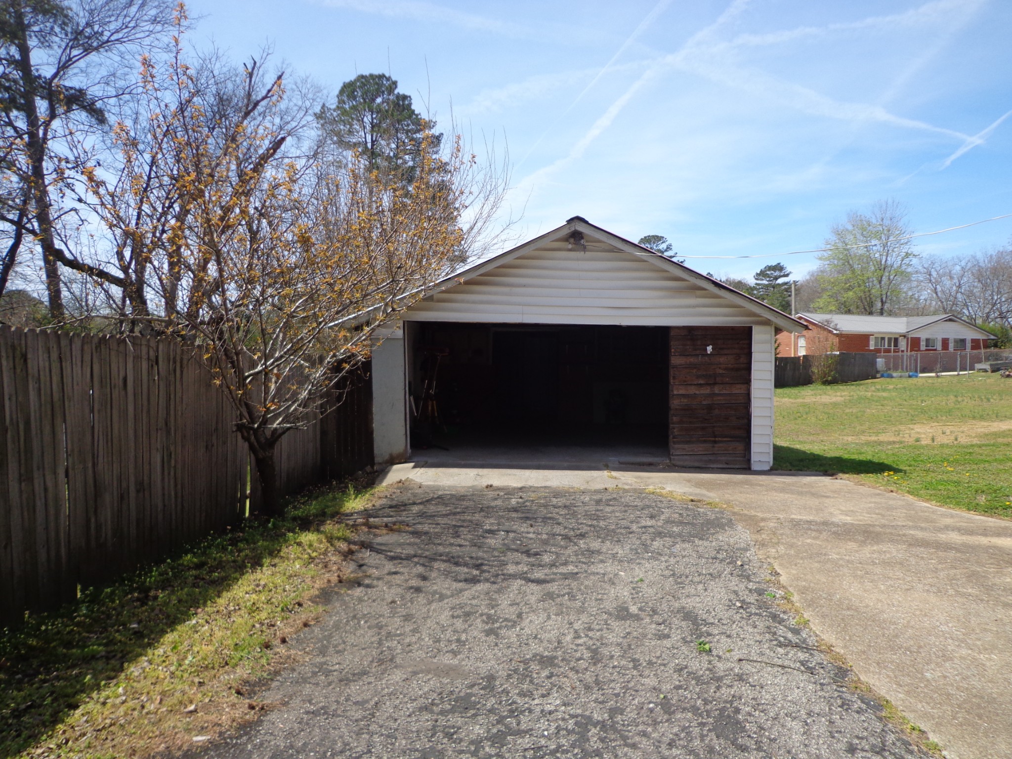 181 Washington Avenue Camden, TN 38320 - Photo 56 of 68 a front view of a house with a yard and garage