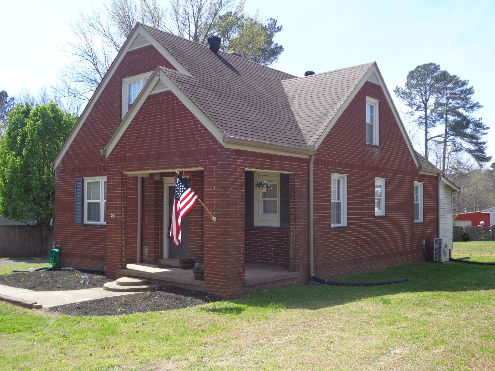 181 Washington Avenue Camden, TN 38320 - Photo 63 of 68 a front view of a house with garden