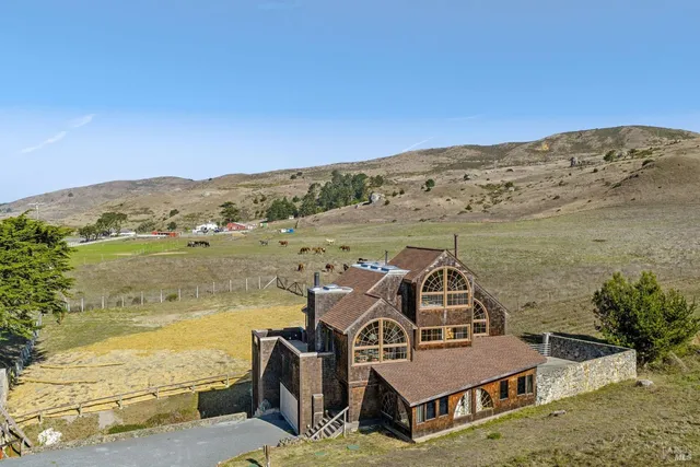 an aerial view of a house with a ocean view