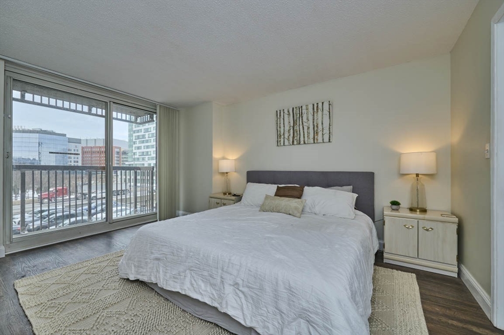 10 Museum Way, Unit 525 Cambridge, MA 02141 - Photo 11 of 22 a large bed sitting in a bedroom next to a window