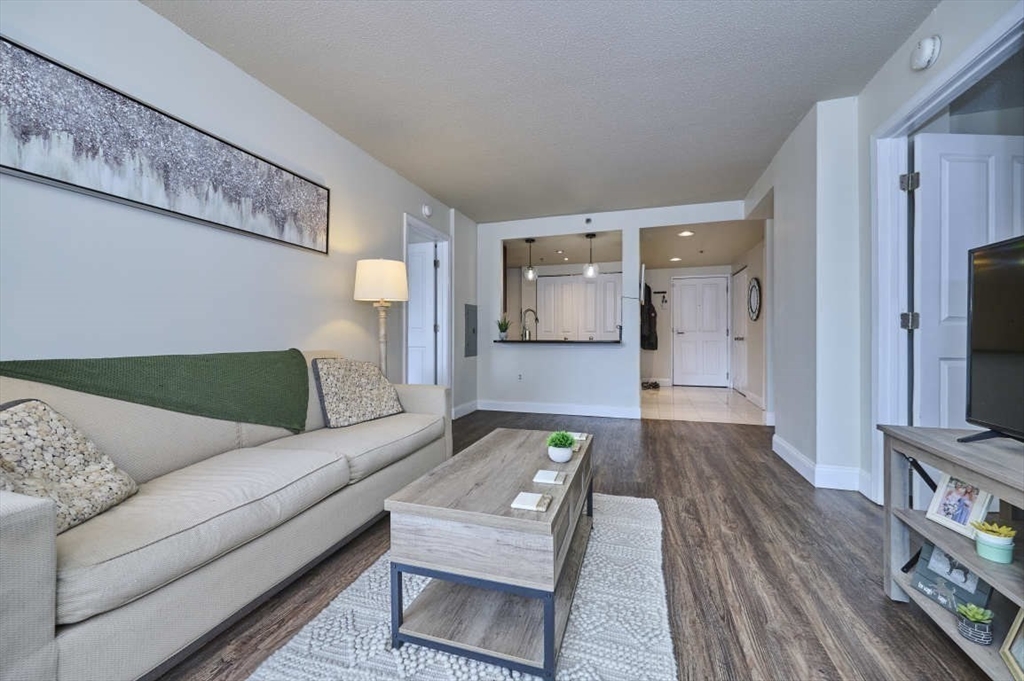 10 Museum Way, Unit 525 Cambridge, MA 02141 - Photo 2 of 22 a living room with furniture and a flat screen tv