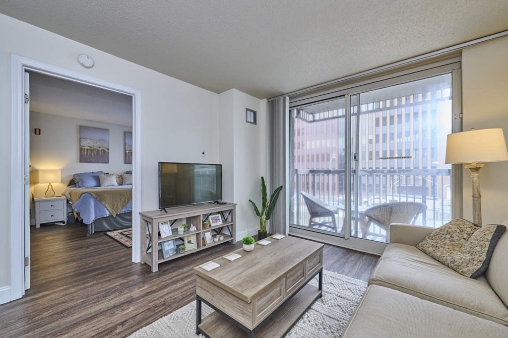 10 Museum Way, Unit 525 Cambridge, MA 02141 - Photo 4 of 22 a living room with furniture and a flat screen tv
