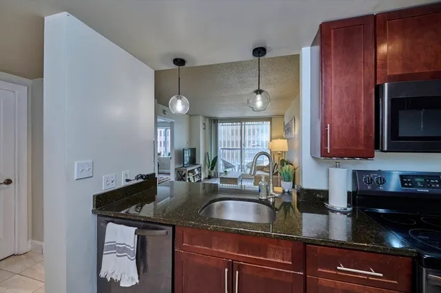 a spacious bedroom with a bed and a lamp