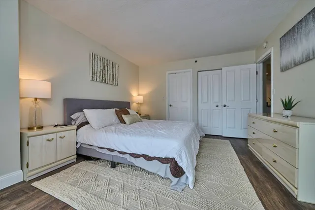 a large bed sitting in a bedroom next to a window