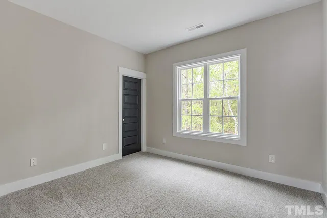 a view of an empty room and closet area