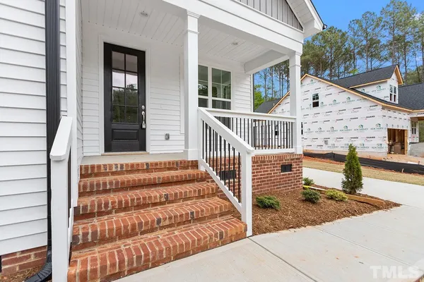 a view of a house with wooden floor and fence