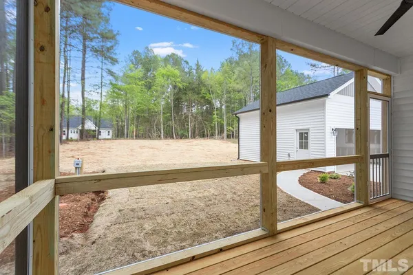 a view of a balcony with floor to ceiling windows with wooden floor