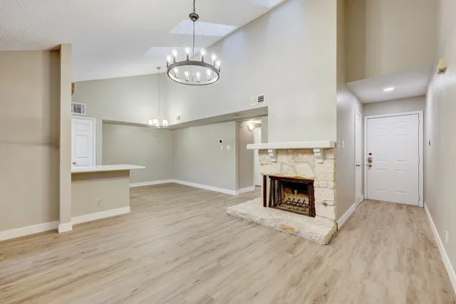 a view of a livingroom with a fireplace and chandelier fan