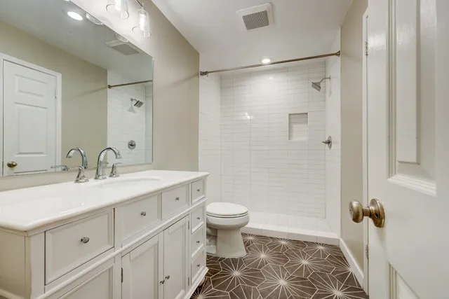 a bathroom with a sink toilet and shower