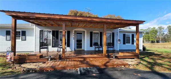 a view of a house with backyard and porch