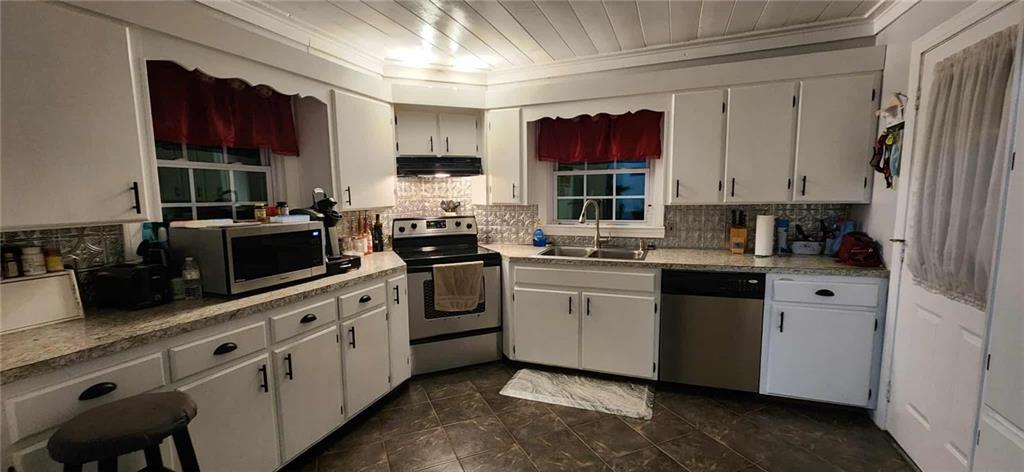 246 Defoor Road Resaca, GA 30735 - Photo 24 of 35 a kitchen with white cabinets sink and stainless steel appliances