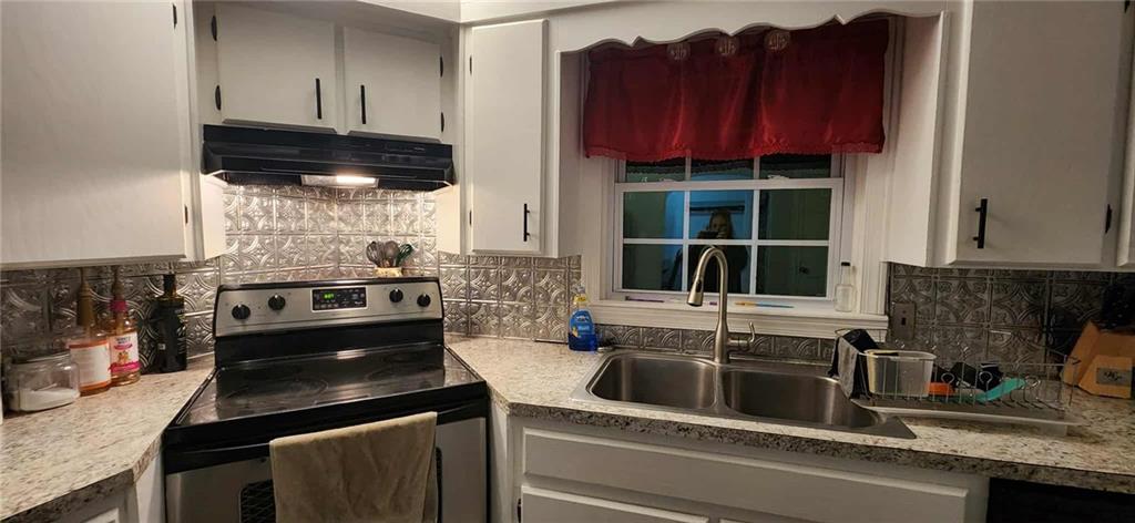 246 Defoor Road Resaca, GA 30735 - Photo 25 of 35 a kitchen with a sink stove and cabinets