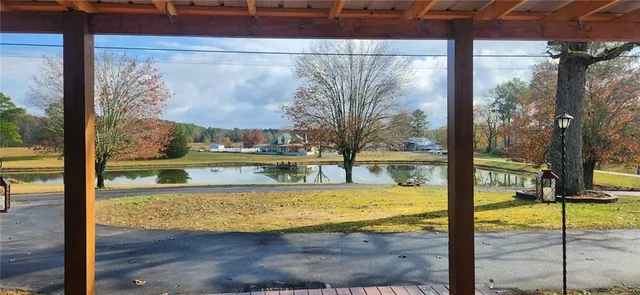a view of a house with backyard and tree