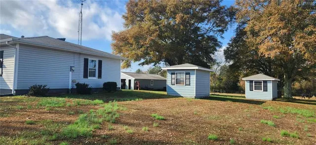 a view of a house with backyard and porch