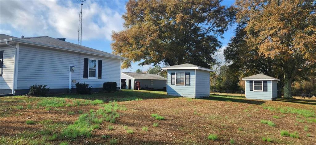246 Defoor Road Resaca, GA 30735 - Photo 6 of 35 a front view of a house with a garden and trees