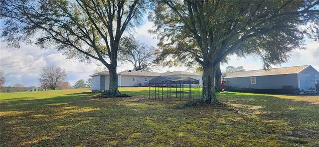 a view of a backyard with sitting area
