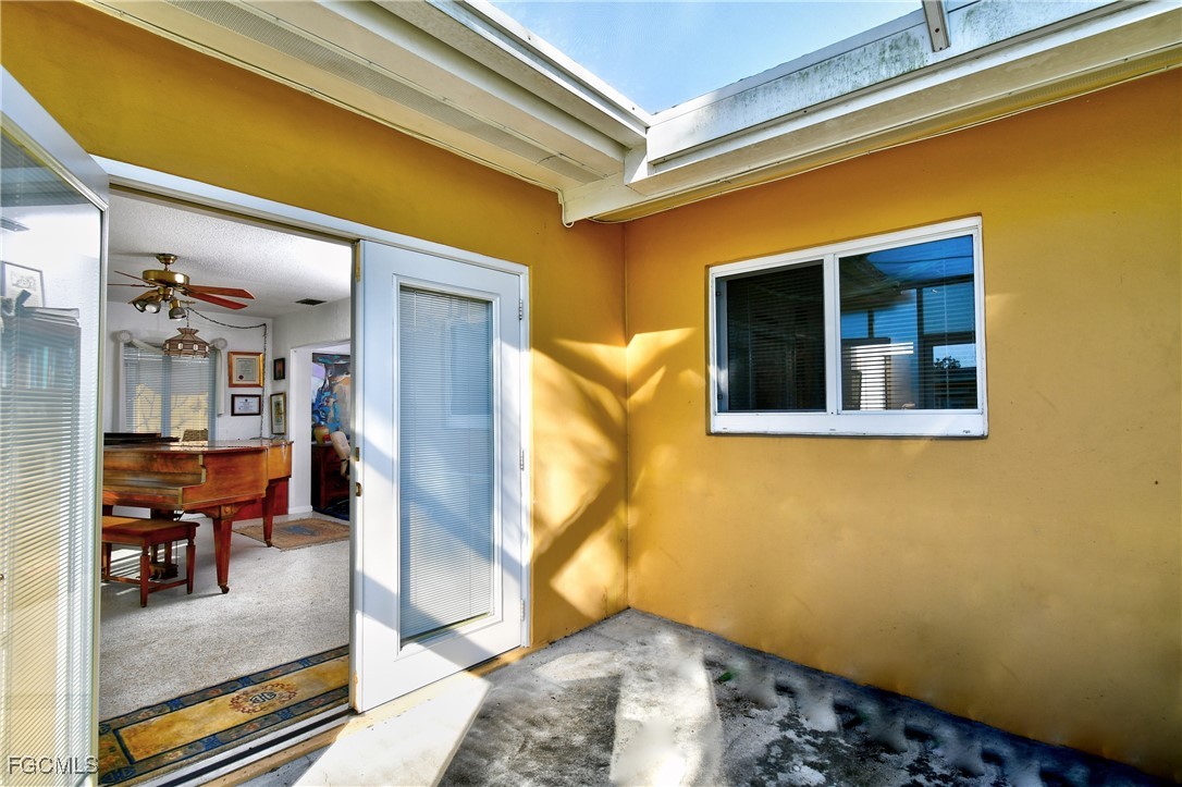 2212 East 6th Street Lehigh Acres, FL 33936 - Photo 18 of 34 a bedroom with a bed and the view of living room