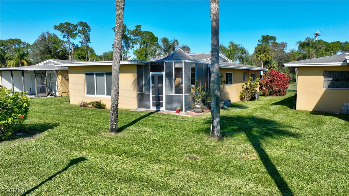 2212 East 6th Street Lehigh Acres, FL 33936 - Photo 26 of 34 a view of a house with a yard and tree