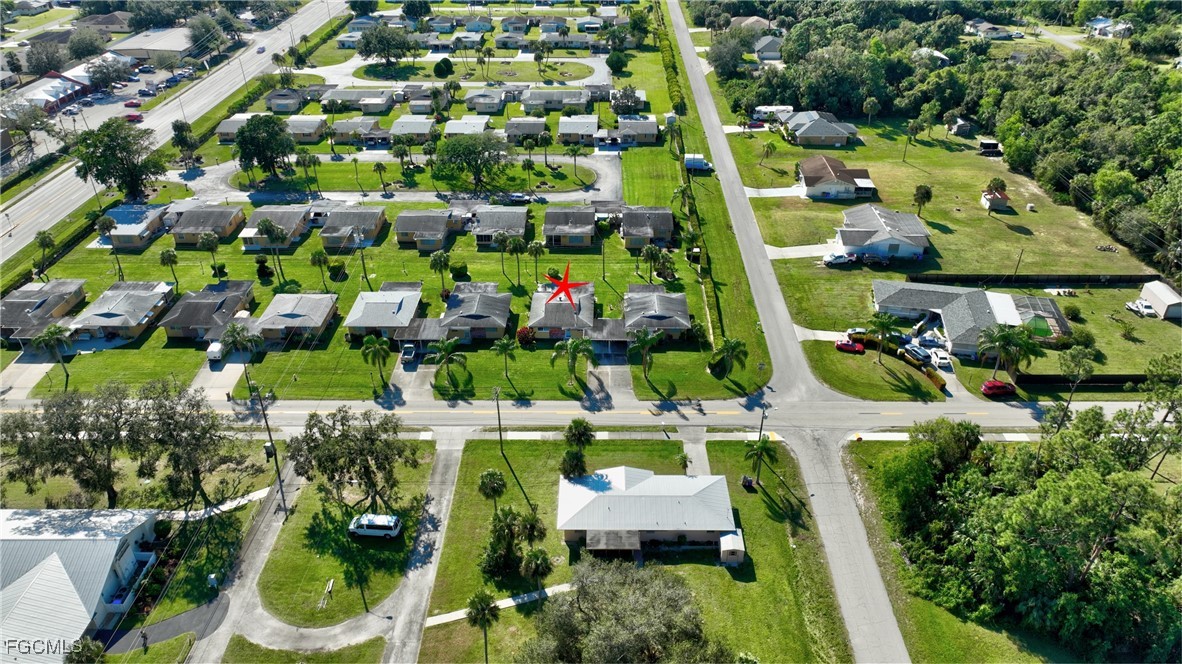 2212 East 6th Street Lehigh Acres, FL 33936 - Photo 28 of 34 an aerial view of residential houses with outdoor space and street view