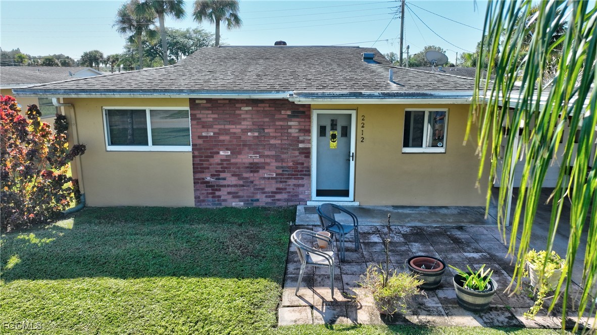 2212 East 6th Street Lehigh Acres, FL 33936 - Photo 6 of 34 a front view of a house with garden