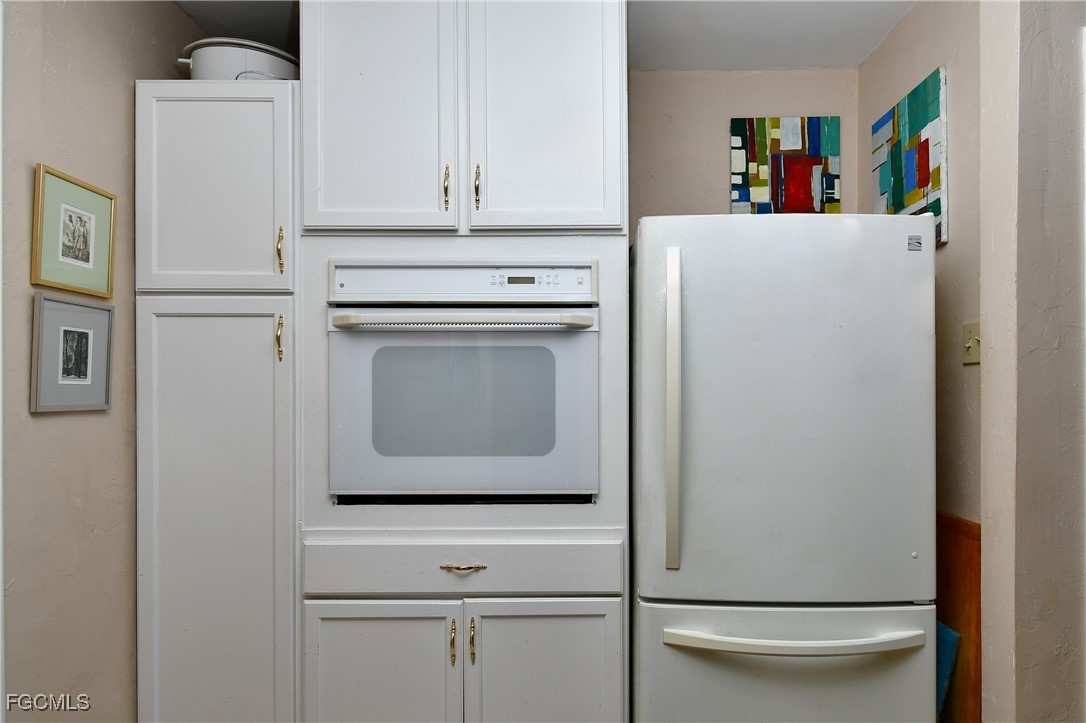 2212 East 6th Street Lehigh Acres, FL 33936 - Photo 8 of 34 a view of washer and dryer with white cabinet