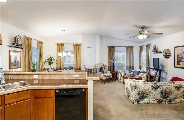 a living room with furniture and large windows