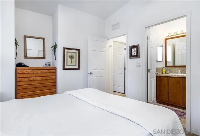 a bedroom with a bed and a dresser