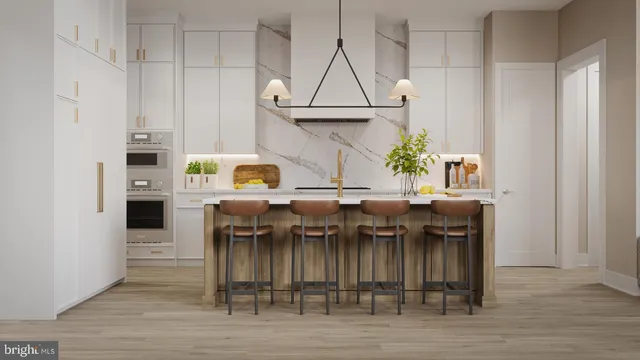 a living room with kitchen island furniture and a flat screen tv