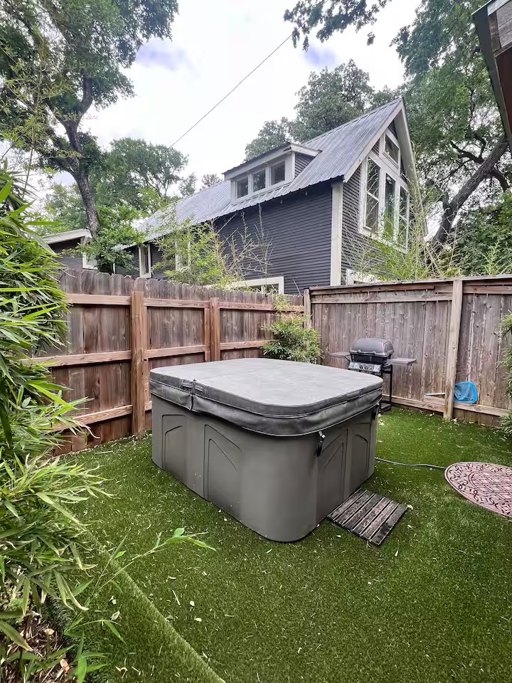 307 East 35th Street, Unit A Austin, TX 78705 - Photo 15 of 40 A private backyard retreat features artificial turf and a covered spa.