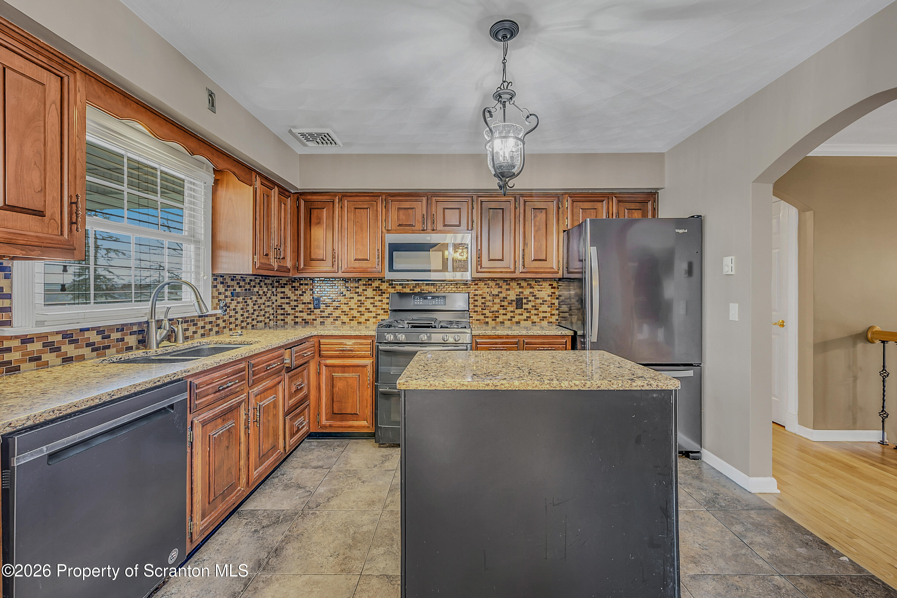 804 School Street Moosic, PA 18507 - Photo 15 of 67 a kitchen with stainless steel appliances granite countertop a sink stove and refrigerator