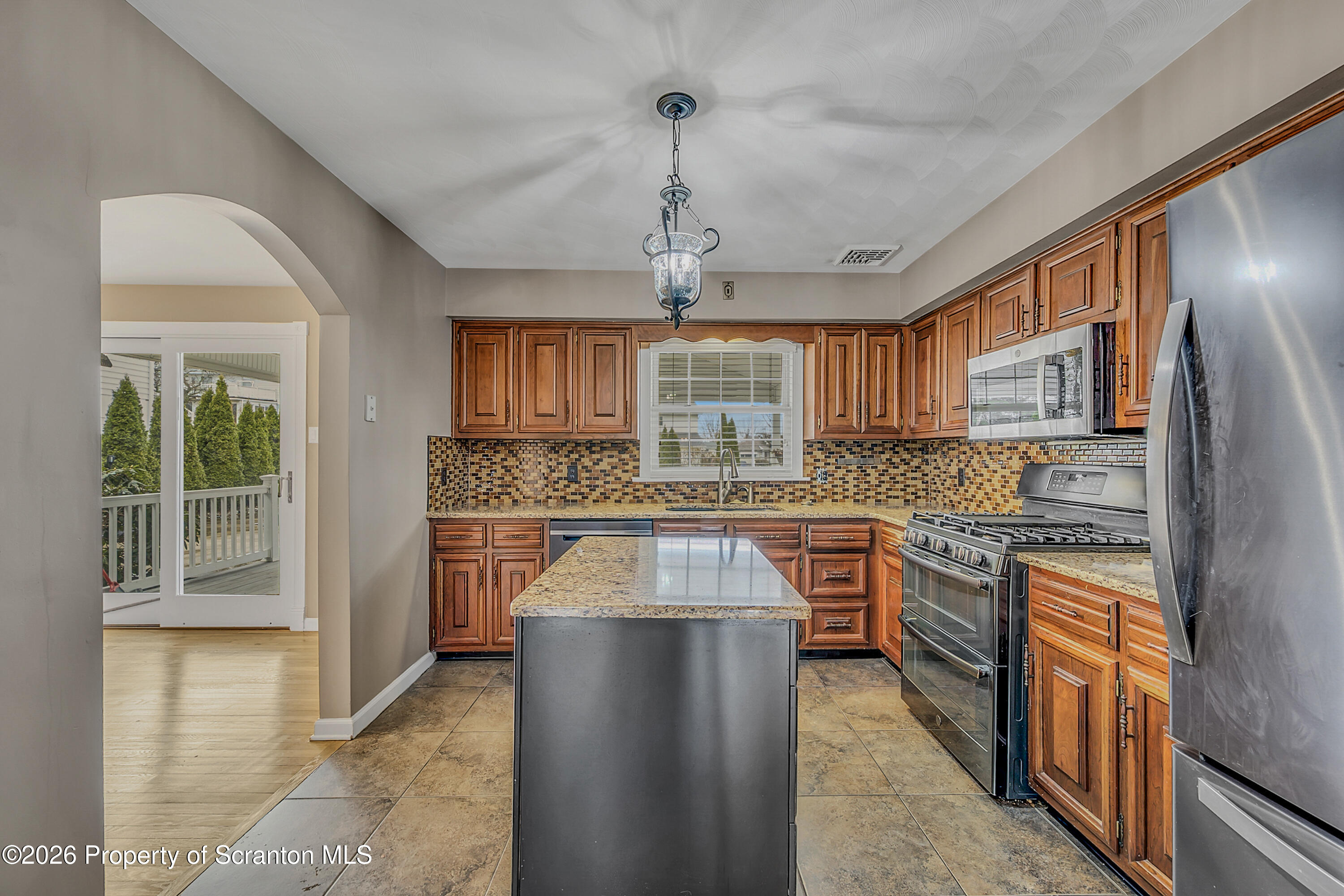 804 School Street Moosic, PA 18507 - Photo 17 of 67 a kitchen with stainless steel appliances granite countertop a stove top oven a sink dishwasher a refrigerator and cabinets with wooden floor