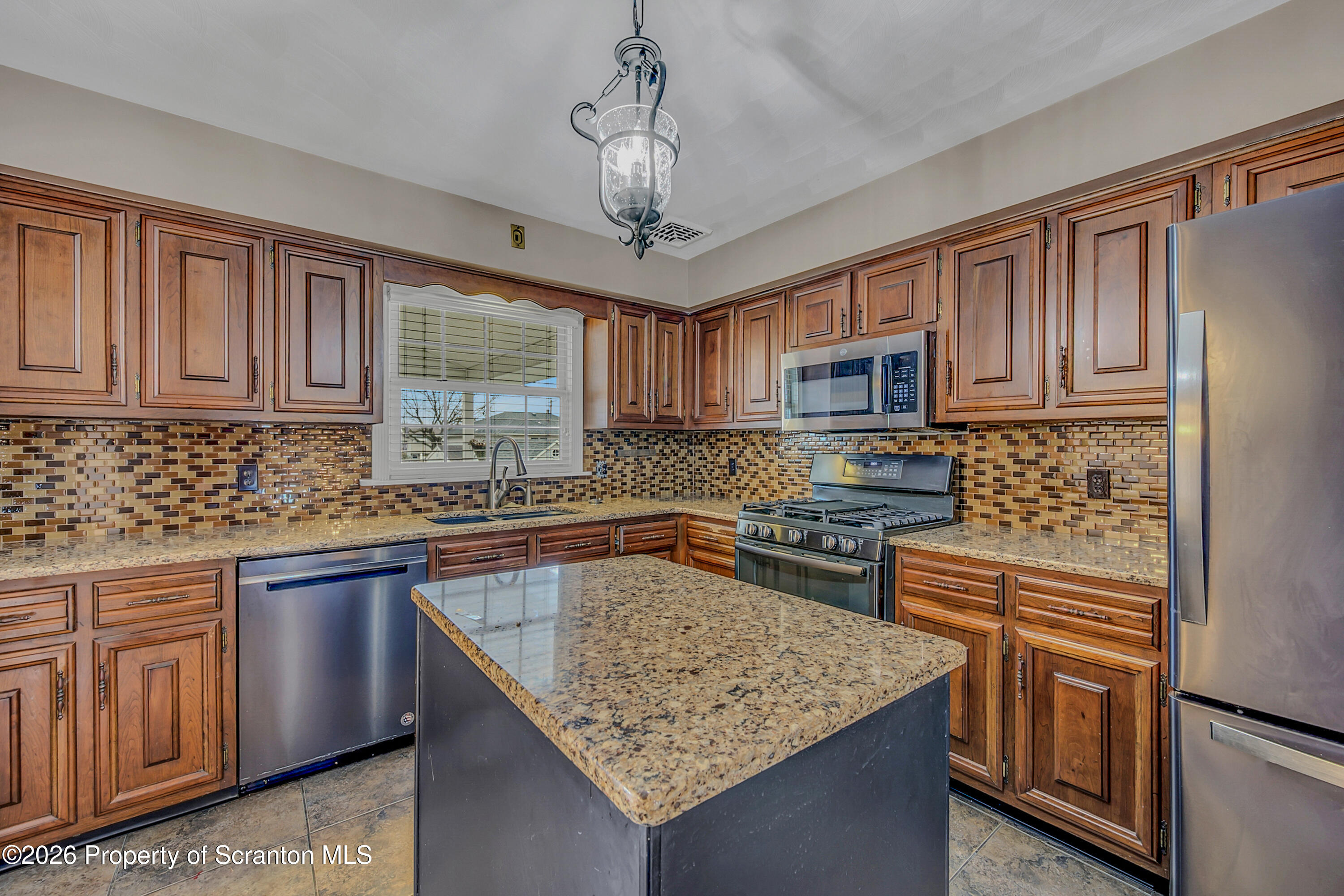 804 School Street Moosic, PA 18507 - Photo 18 of 67 a kitchen with stainless steel appliances granite countertop a sink stove microwave and refrigerator