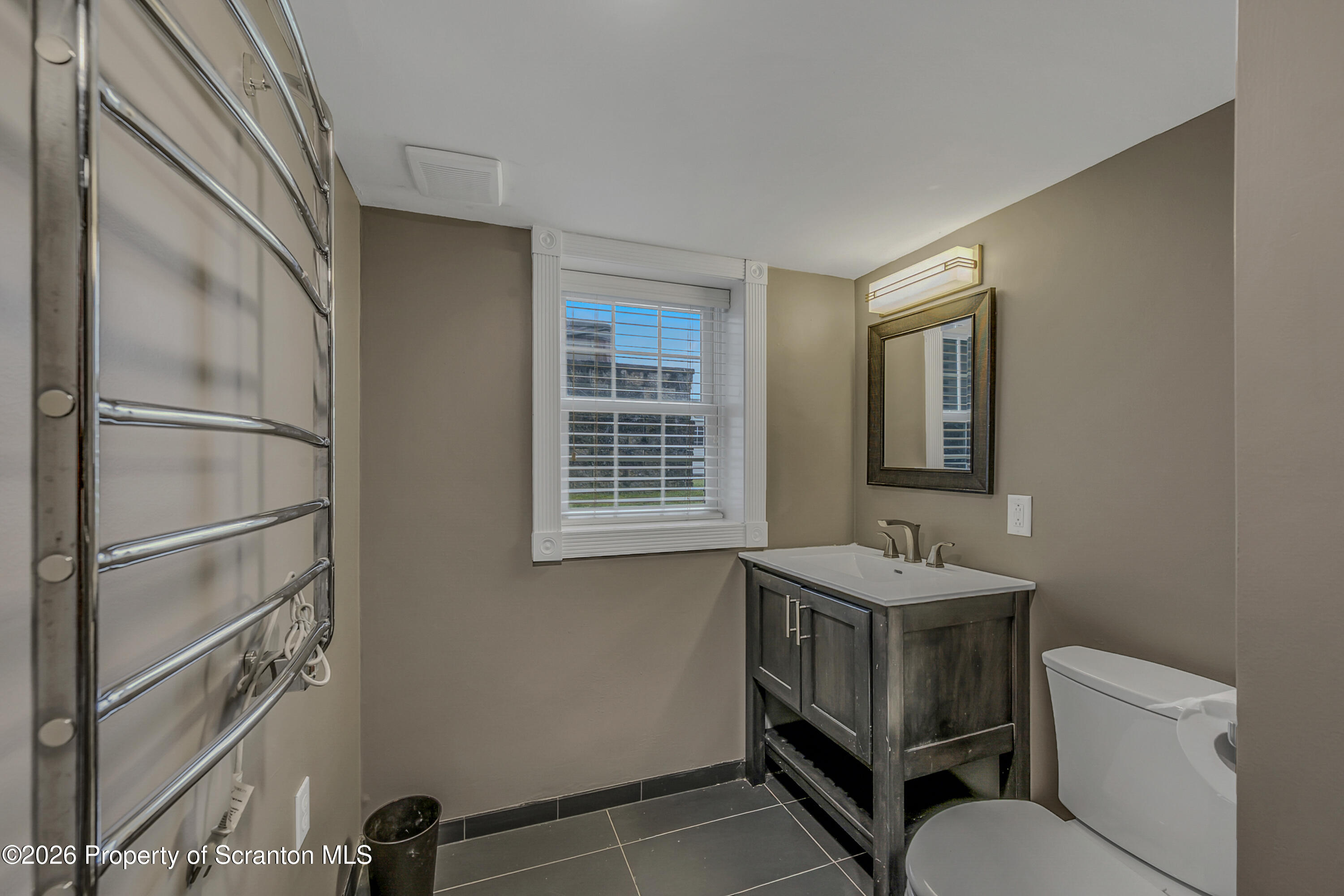 804 School Street Moosic, PA 18507 - Photo 51 of 67 a bathroom with a sink toilet and mirror