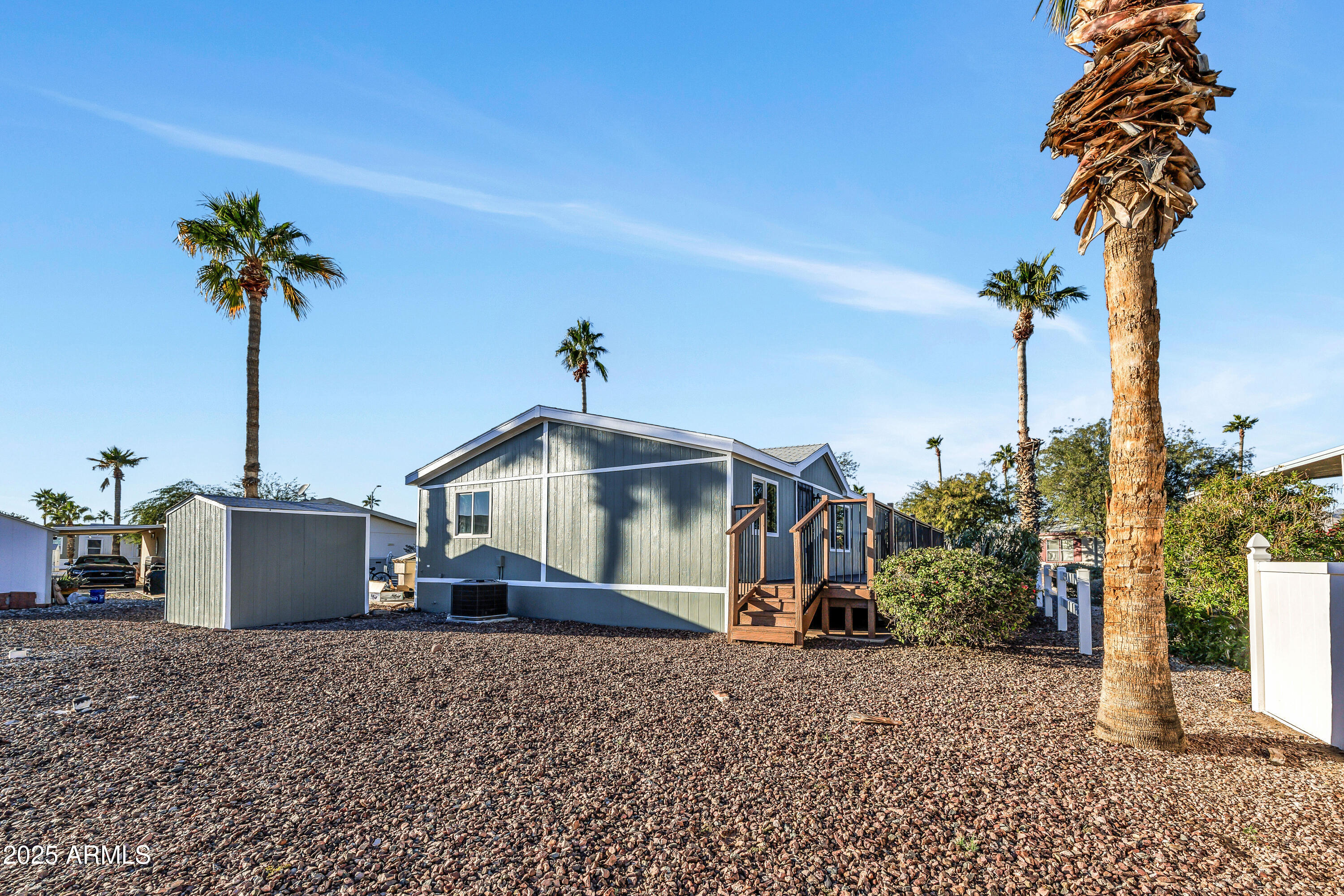 2000 South Apache Road, Unit 220 Buckeye, AZ 85326 - Photo 13 of 25 a front view of a house with a garden and trees