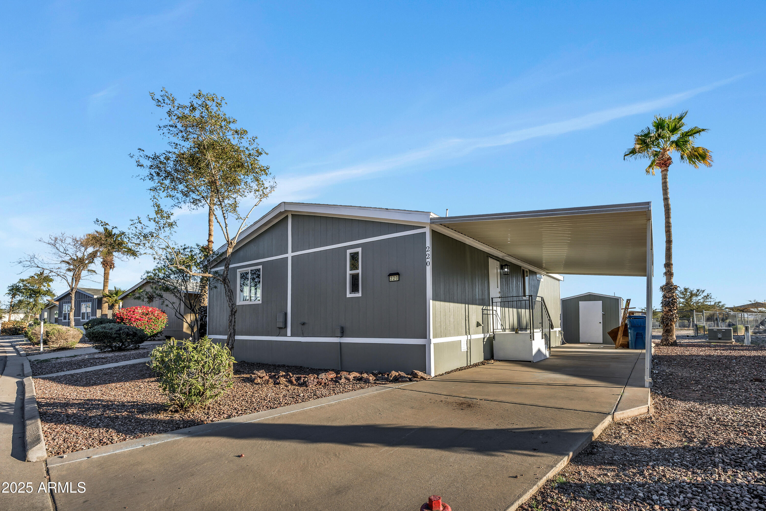 2000 South Apache Road, Unit 220 Buckeye, AZ 85326 - Photo 18 of 25 a front view of a house with a yard and garage