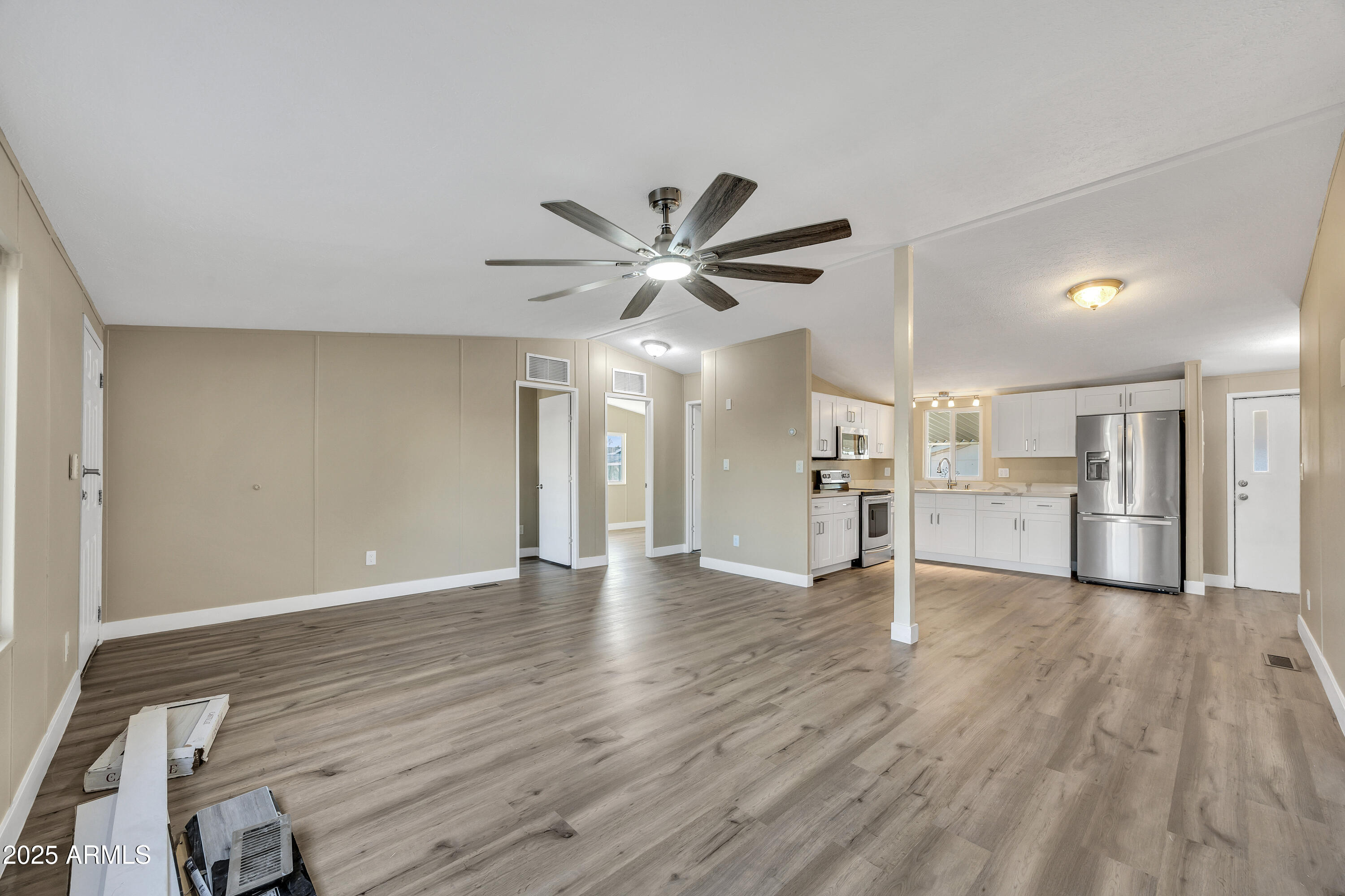 2000 South Apache Road, Unit 220 Buckeye, AZ 85326 - Photo 20 of 25 a view of an empty room with wooden floor and a ceiling fan