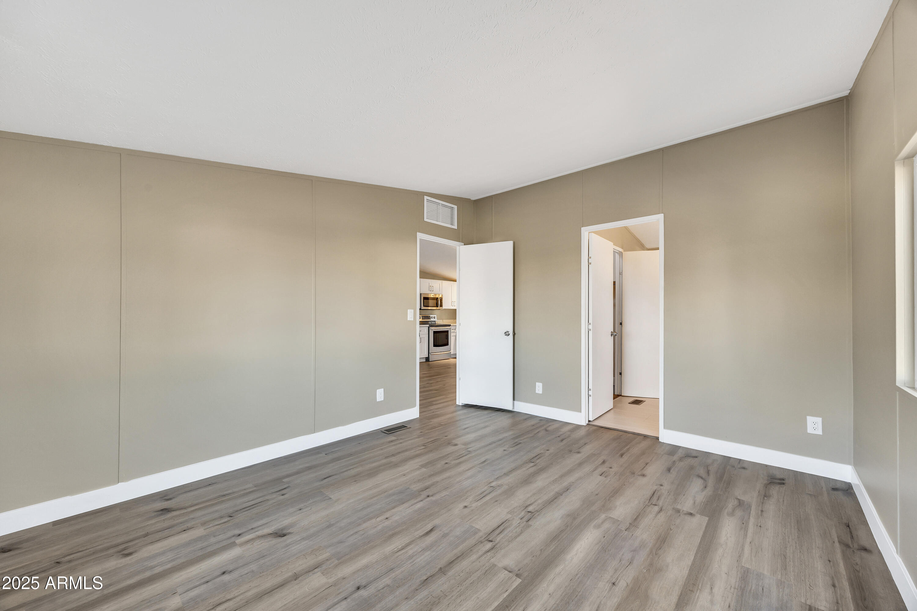 2000 South Apache Road, Unit 220 Buckeye, AZ 85326 - Photo 2 of 25 a view of an empty room with wooden floor