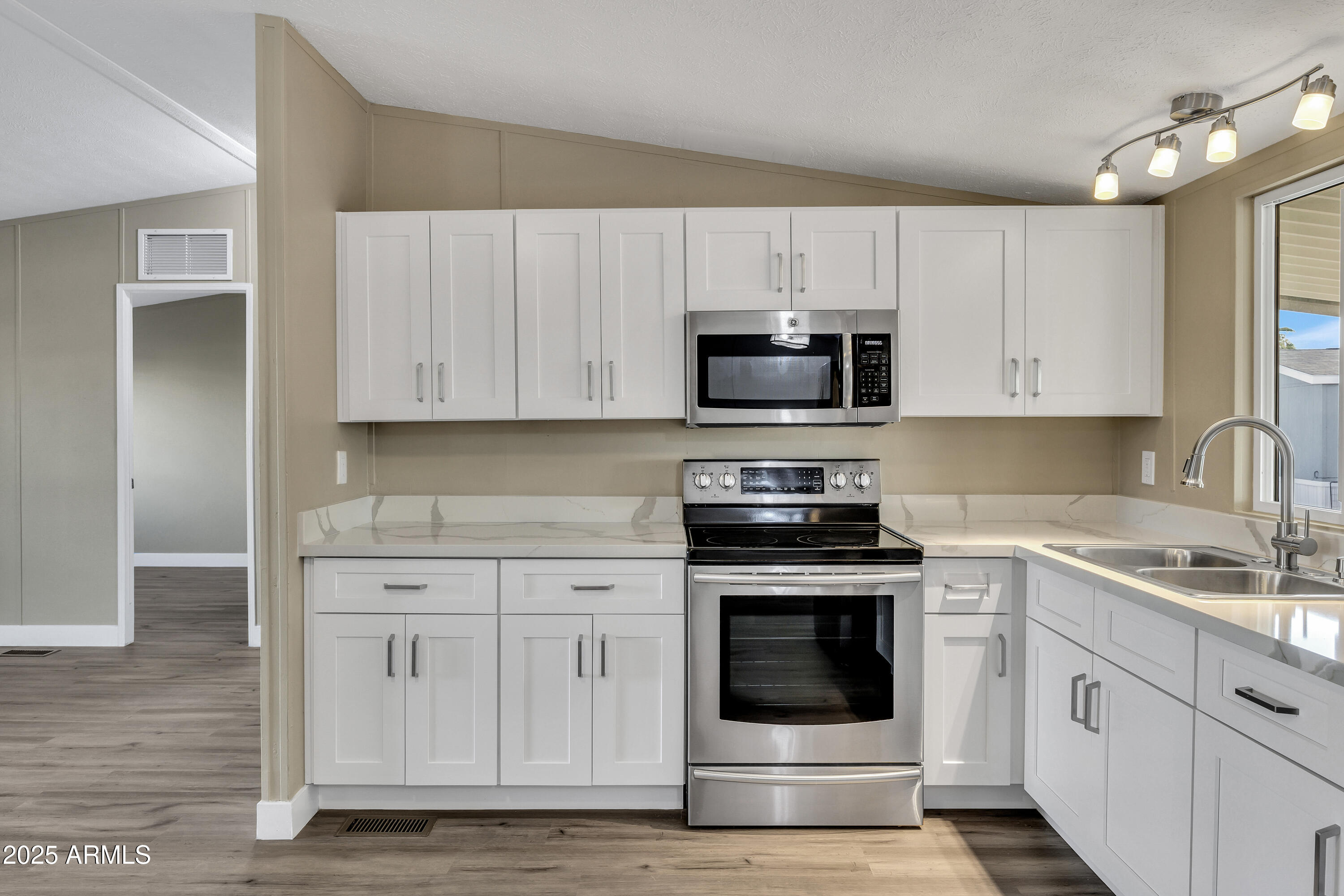 2000 South Apache Road, Unit 220 Buckeye, AZ 85326 - Photo 23 of 25 a kitchen with cabinets stainless steel appliances and sink