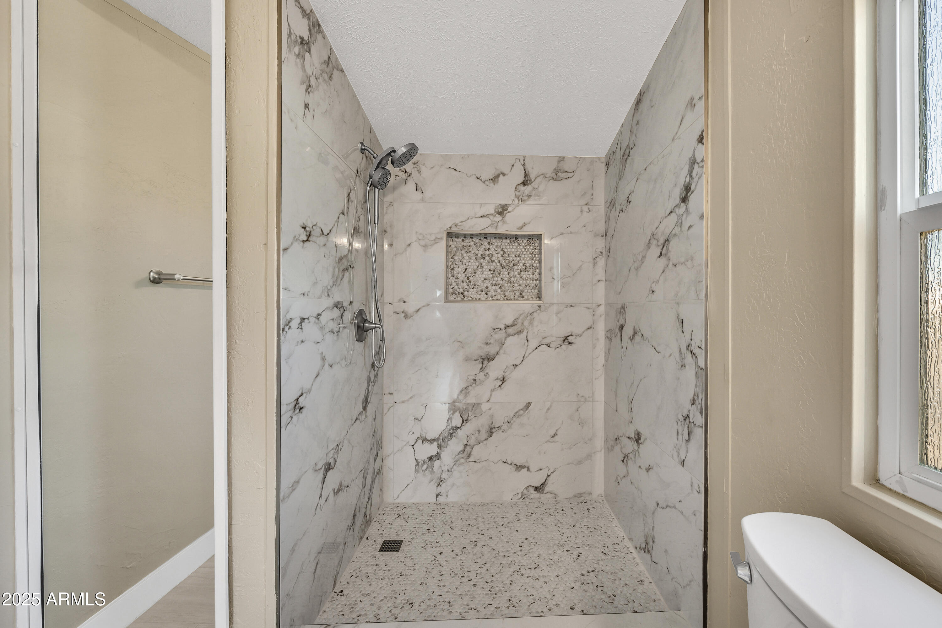 2000 South Apache Road, Unit 220 Buckeye, AZ 85326 - Photo 4 of 25 a bathroom with a shower toilet and sink