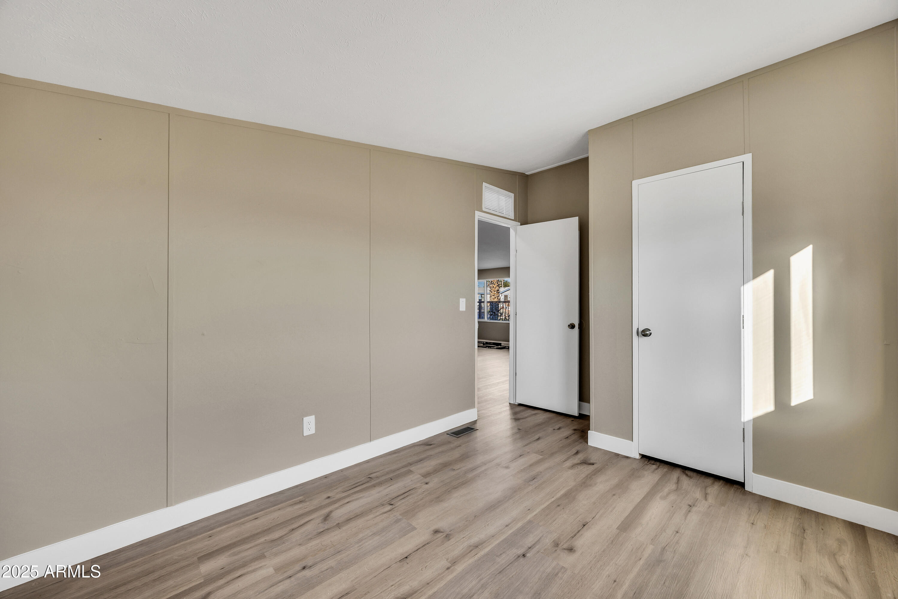 2000 South Apache Road, Unit 220 Buckeye, AZ 85326 - Photo 7 of 25 a view of an empty room with wooden floor and closet
