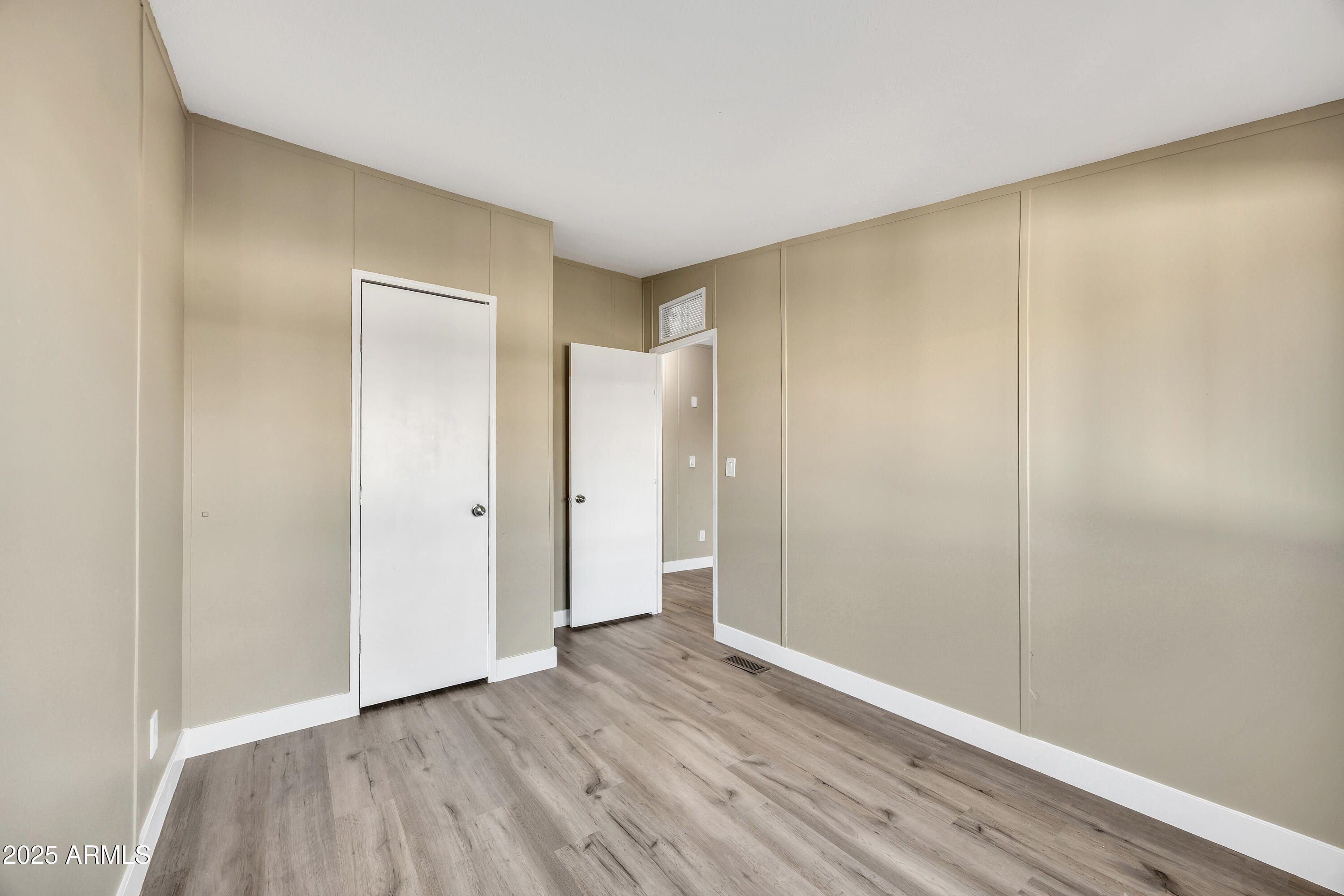 2000 South Apache Road, Unit 220 Buckeye, AZ 85326 - Photo 10 of 25 a view of an empty room with wooden floor