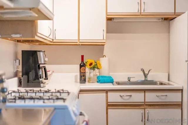 a kitchen with a sink and cabinets
